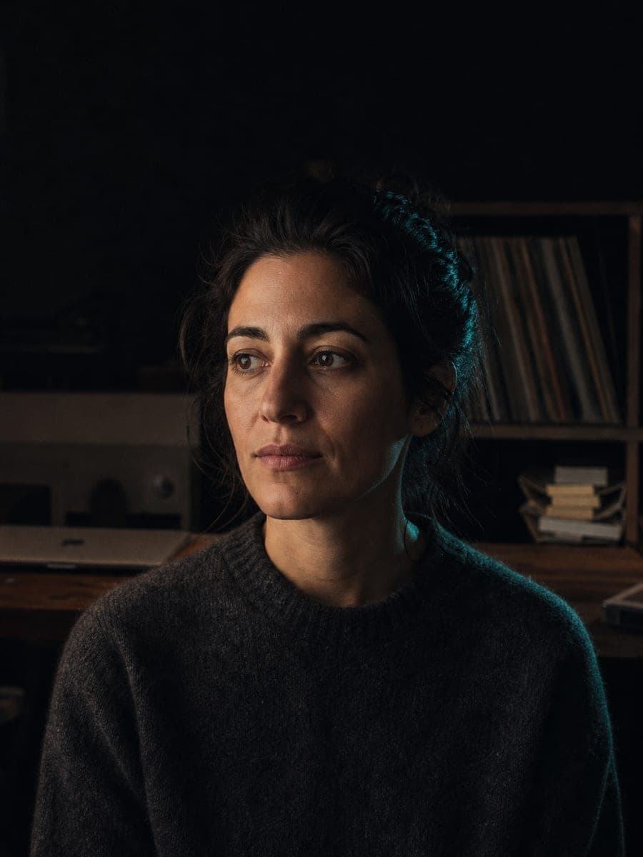 Rendered portrait of Elena, the DOT Dominus music manager agent, in a dim record room.